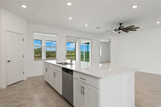 kitchen with dishwasher, ceiling fan, a kitchen island with sink, sink, and light tile floors