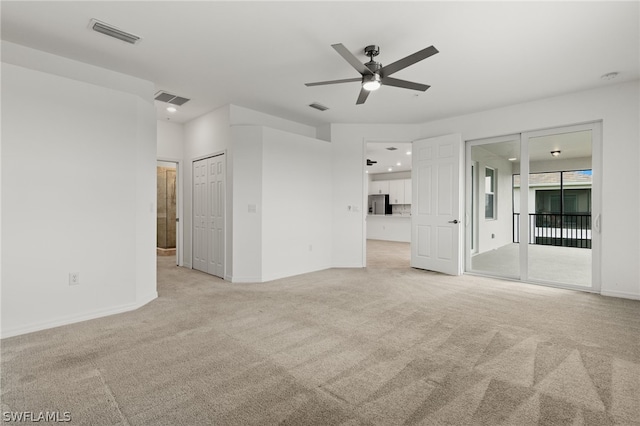 unfurnished room featuring ceiling fan and light colored carpet