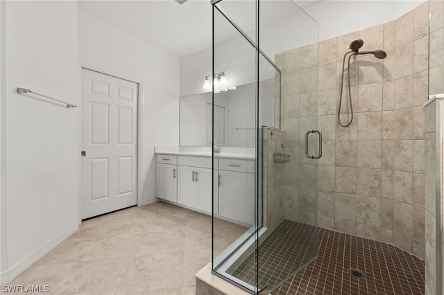 bathroom featuring walk in shower, vanity, and tile floors