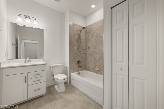 full bathroom featuring tile floors, vanity, toilet, and tiled shower / bath combo