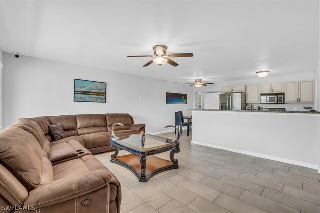 living room featuring ceiling fan and light tile floors