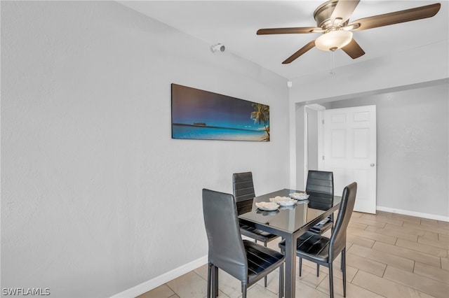 dining area featuring ceiling fan and light tile floors