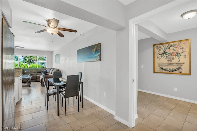 dining space featuring ceiling fan and light tile flooring