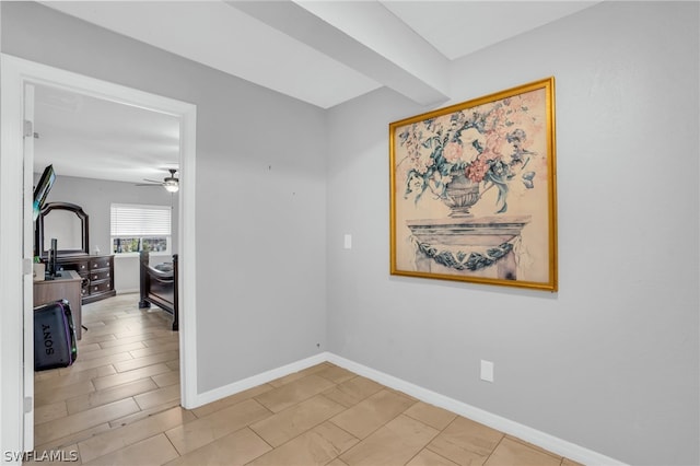 unfurnished room featuring beamed ceiling, ceiling fan, and tile flooring