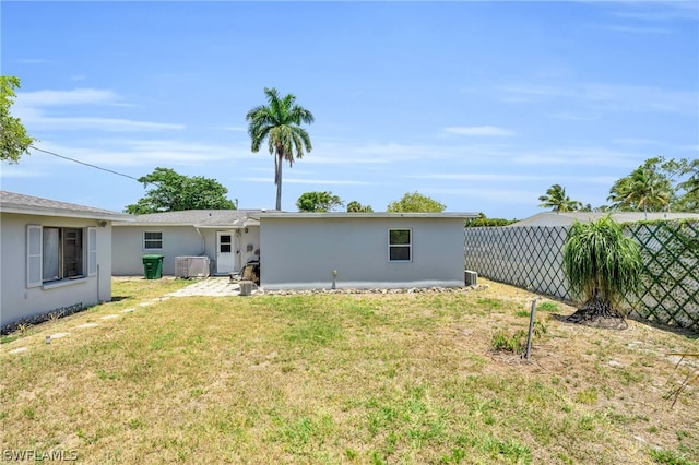 rear view of house with a yard