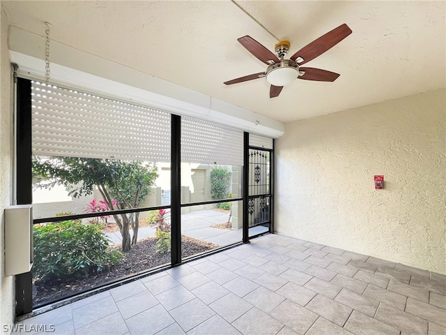 spare room featuring ceiling fan and light tile floors