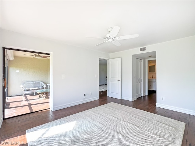 unfurnished bedroom featuring ceiling fan and dark wood-type flooring