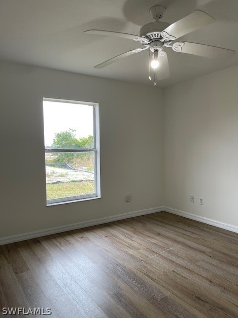 unfurnished room featuring ceiling fan and hardwood / wood-style flooring