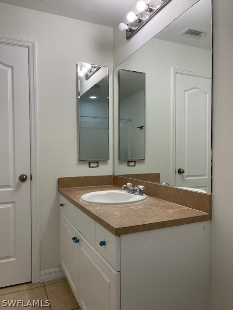 bathroom with tile floors and vanity