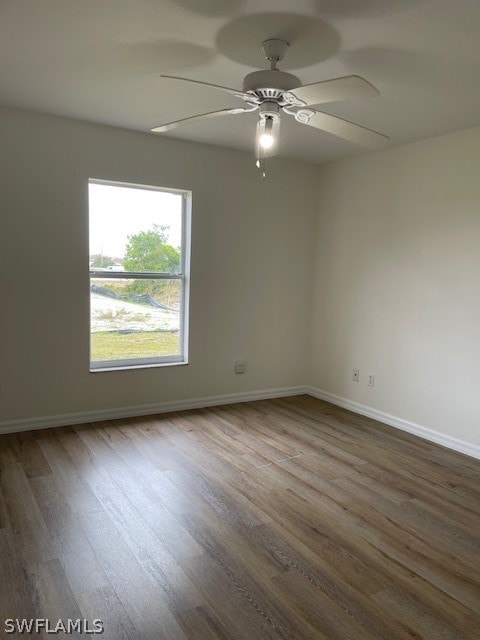 unfurnished room with ceiling fan and hardwood / wood-style flooring