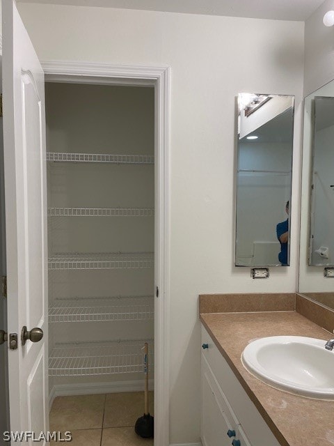 bathroom featuring tile flooring and oversized vanity