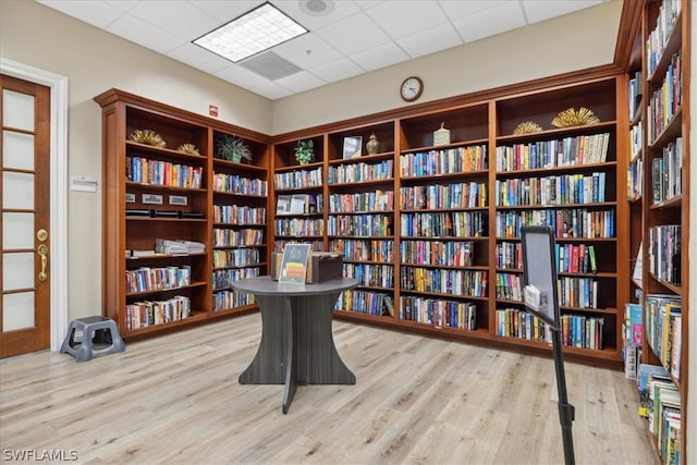 office with a drop ceiling and light hardwood / wood-style floors