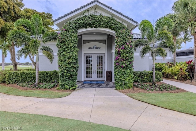 view of exterior entry featuring french doors