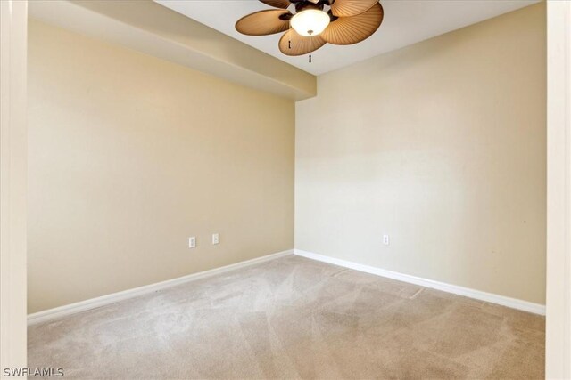 carpeted spare room featuring ceiling fan