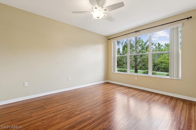 unfurnished room with a healthy amount of sunlight, ceiling fan, and hardwood / wood-style floors