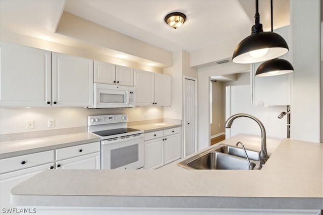 kitchen with white cabinets, hanging light fixtures, white appliances, and sink