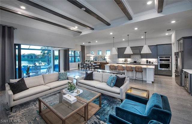 living room featuring beamed ceiling, dark hardwood / wood-style floors, and crown molding