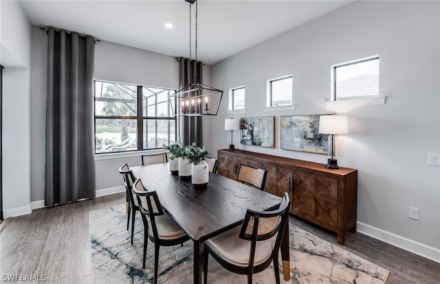 dining space with an inviting chandelier and hardwood / wood-style floors