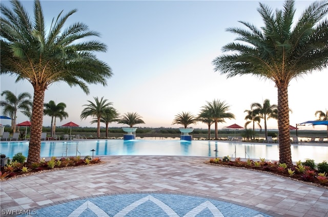 pool at dusk with a water view