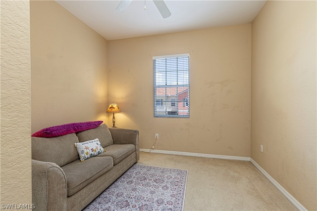 carpeted living room featuring ceiling fan