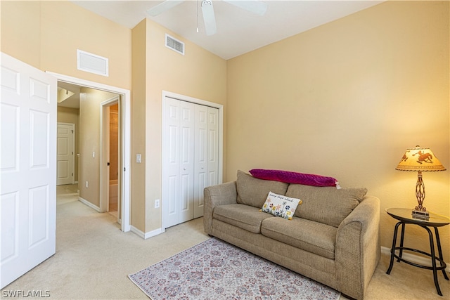 carpeted living room featuring ceiling fan