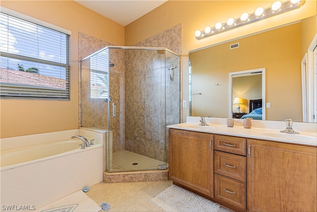 bathroom featuring a wealth of natural light, double sink, tile floors, and plus walk in shower