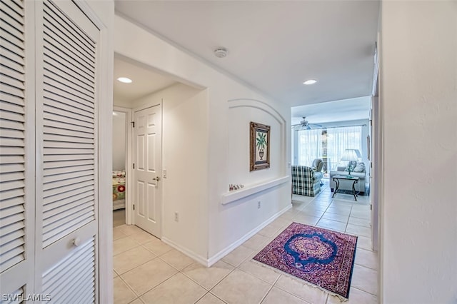 hall featuring light tile floors