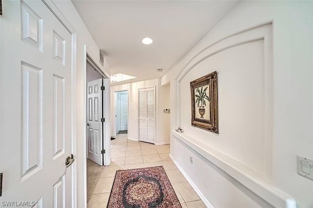 corridor with light tile flooring