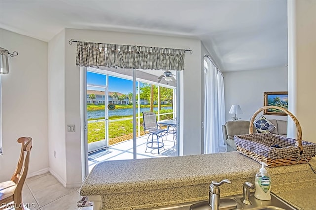 interior space with light tile flooring and a water view