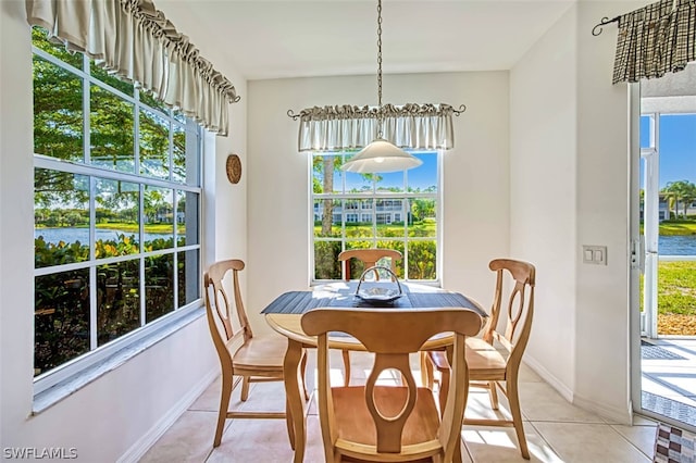 tiled dining area featuring a water view