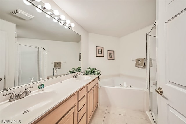 bathroom with dual sinks, tile flooring, oversized vanity, and plus walk in shower