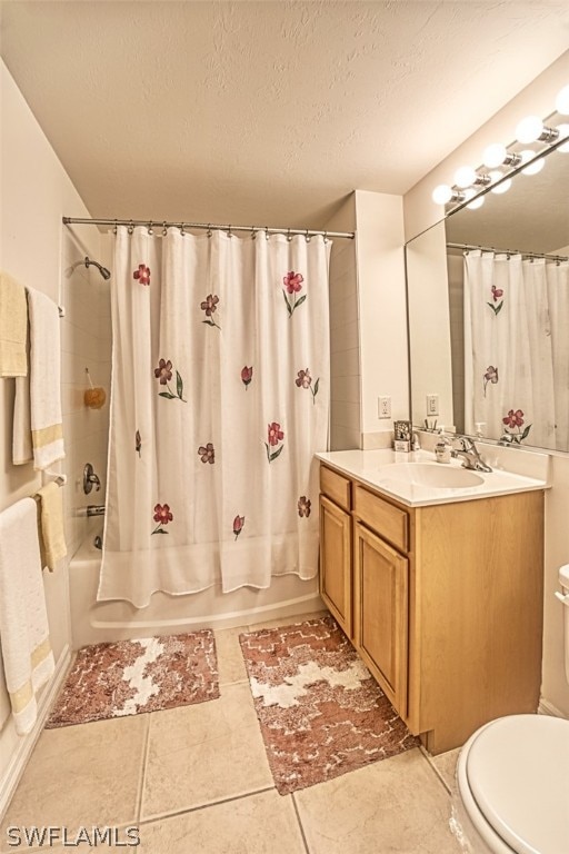 full bathroom with tile flooring, a textured ceiling, shower / tub combo with curtain, toilet, and vanity