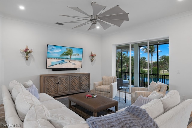 living room featuring ornamental molding, ceiling fan, a water view, and hardwood / wood-style flooring