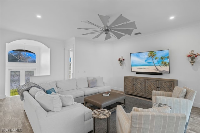 living room featuring crown molding and hardwood / wood-style floors