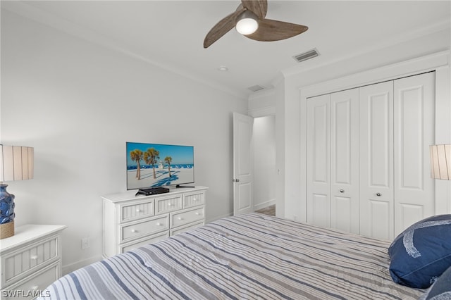 bedroom with a closet, ceiling fan, and ornamental molding