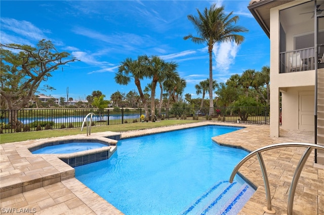 view of pool with an in ground hot tub