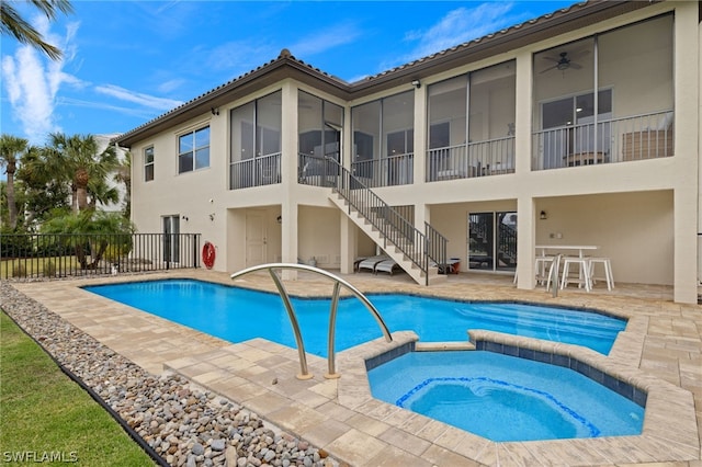 view of swimming pool with a patio area, ceiling fan, and an in ground hot tub