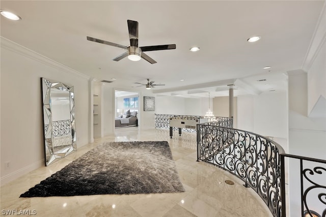 corridor featuring light tile flooring, ornate columns, and crown molding