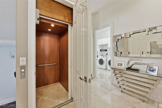 interior space with elevator, tile floors, and washer and dryer