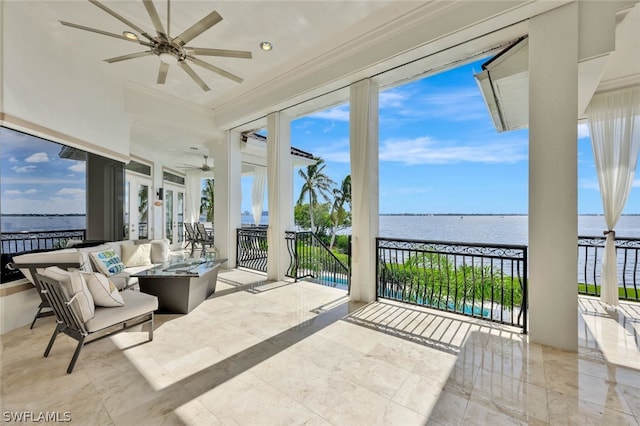 exterior space with ceiling fan and a water view