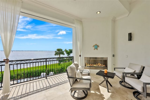 view of patio with a balcony and a water view