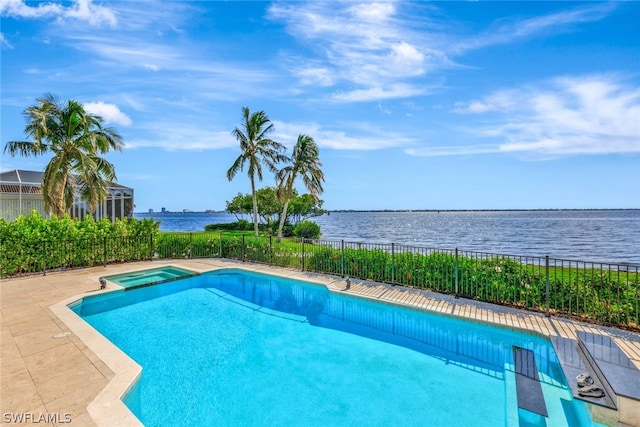 view of swimming pool featuring an in ground hot tub and a water view