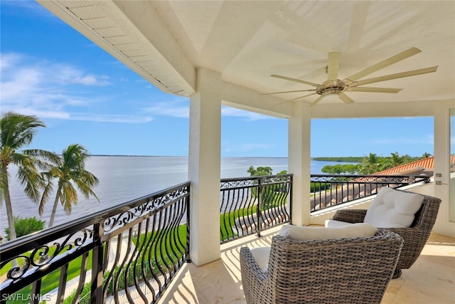 balcony featuring ceiling fan and a water view