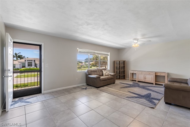 living room with ceiling fan and light tile floors