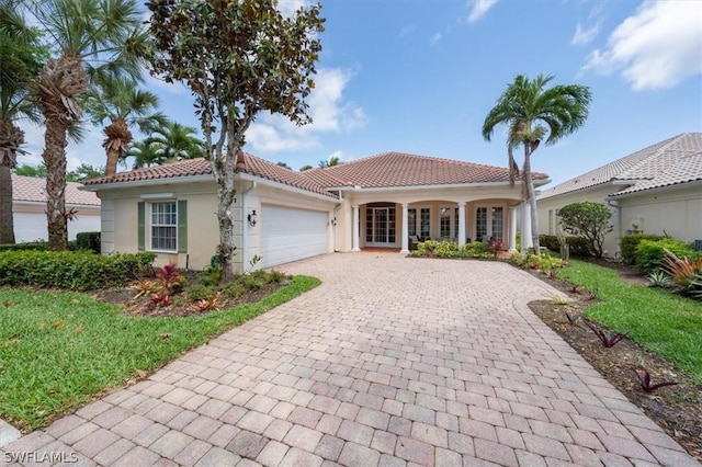 mediterranean / spanish-style home with a garage