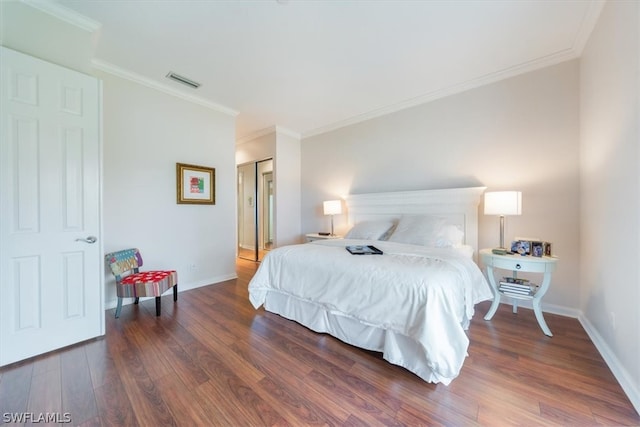 bedroom featuring dark hardwood / wood-style floors, a closet, and ornamental molding