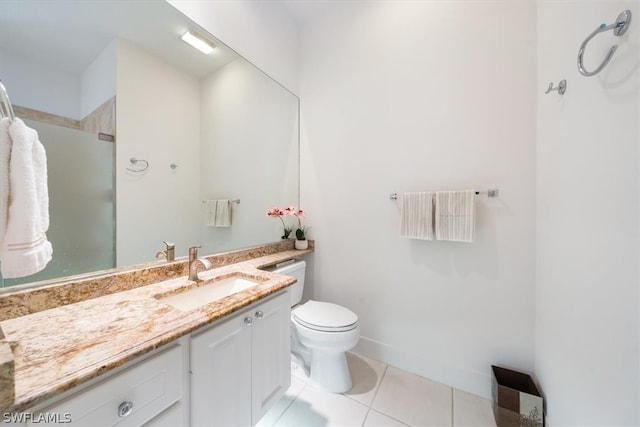 bathroom with tile patterned floors, vanity, toilet, and a shower