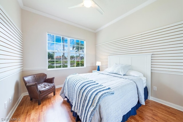 bedroom featuring ceiling fan, ornamental molding, and hardwood / wood-style flooring