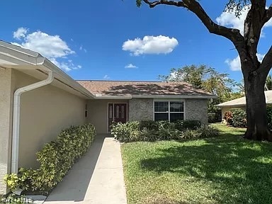 doorway to property with a yard