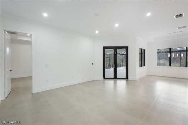 tiled spare room featuring french doors and crown molding